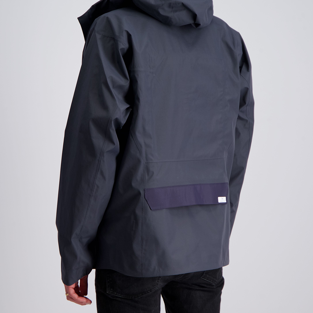 Photograph of a jacket upgraded with LunaMicro's pump technology for moisture management. The pump isn't visible in the back panel of the jacket. Only the flap that covers the slot in the jacket where water comes out can be seen.