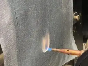 LunaMicro pump enduring a propane flame during a flame test.